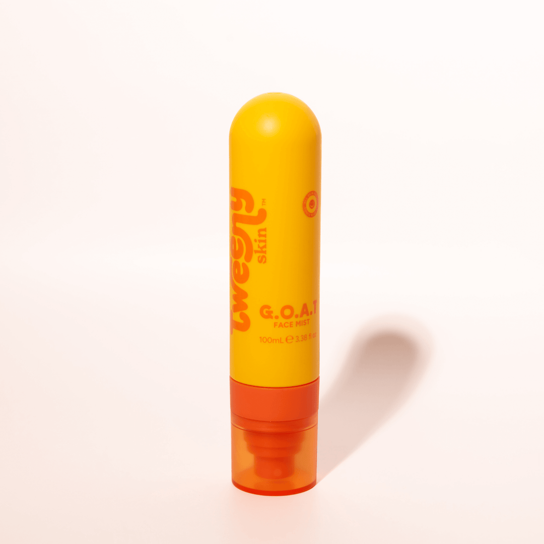 Bright yellow and orange bottle of Tweeny Skin G.O.A.T. Hypochlorous Face Mist, standing upright against a clean white background.