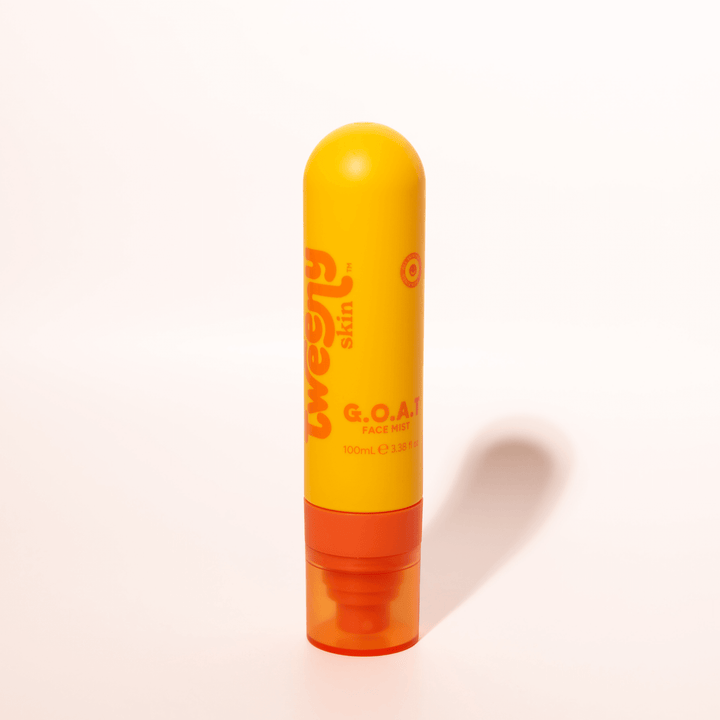 Bright yellow and orange bottle of Tweeny Skin G.O.A.T. Hypochlorous Face Mist, standing upright against a clean white background.