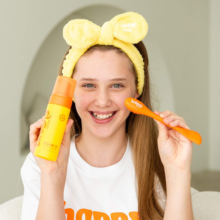 Tween girl using Foam-O Gentle Cleanser with silicone cleansing brush, gentle skincare routine for tweens and teens