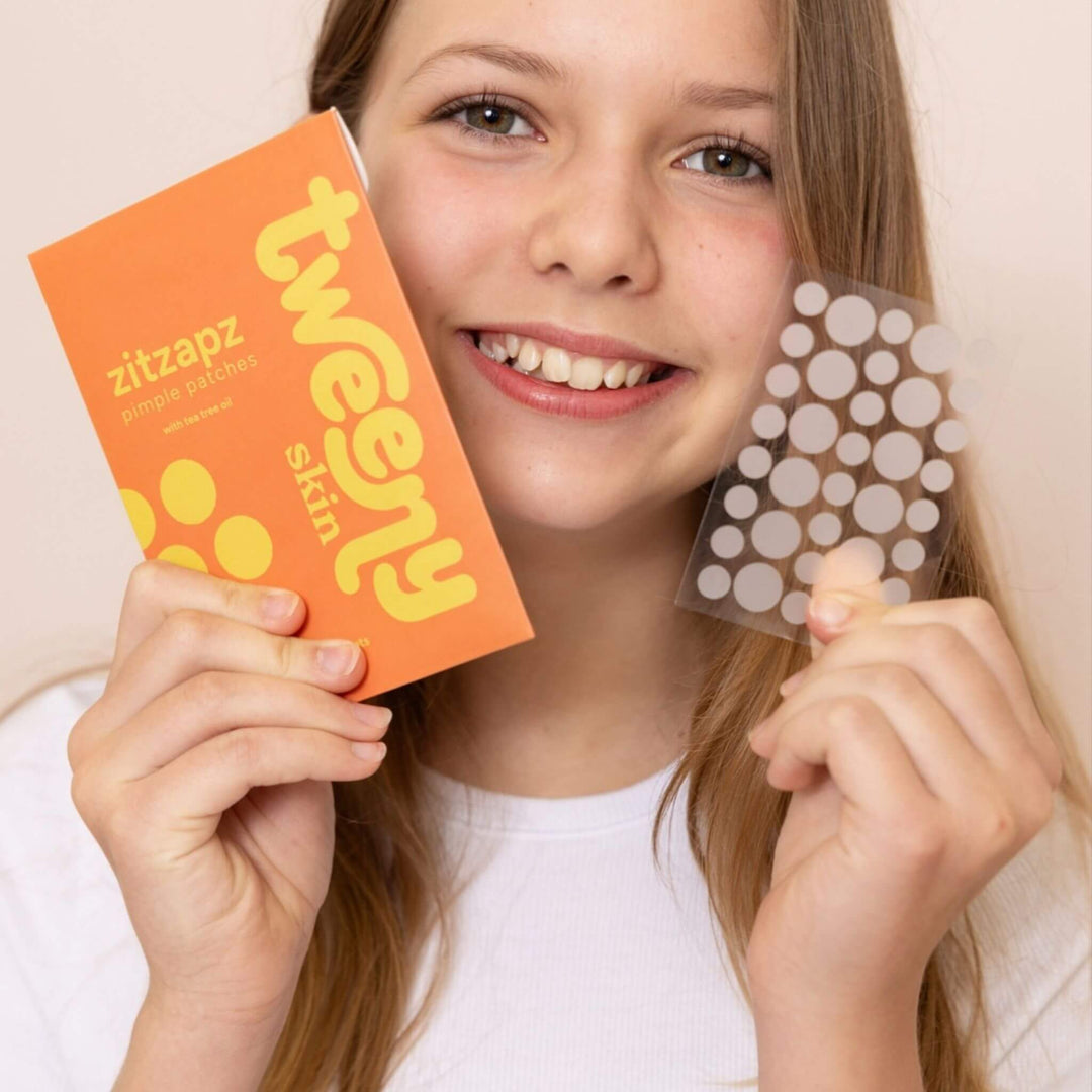 Tween holding ZitZapz pimple patches and hydrocolloid patch sheet, acne solution for tween and teen skin